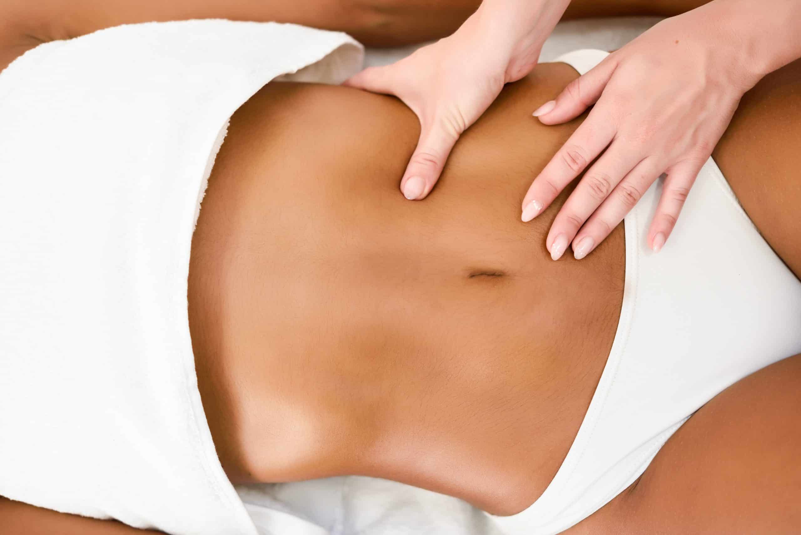Woman receiving abdomen massage in spa wellness center. Beauty and Aesthetic concepts.